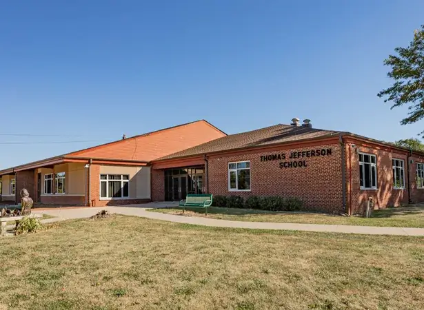 Thomas jefferson school building and statue